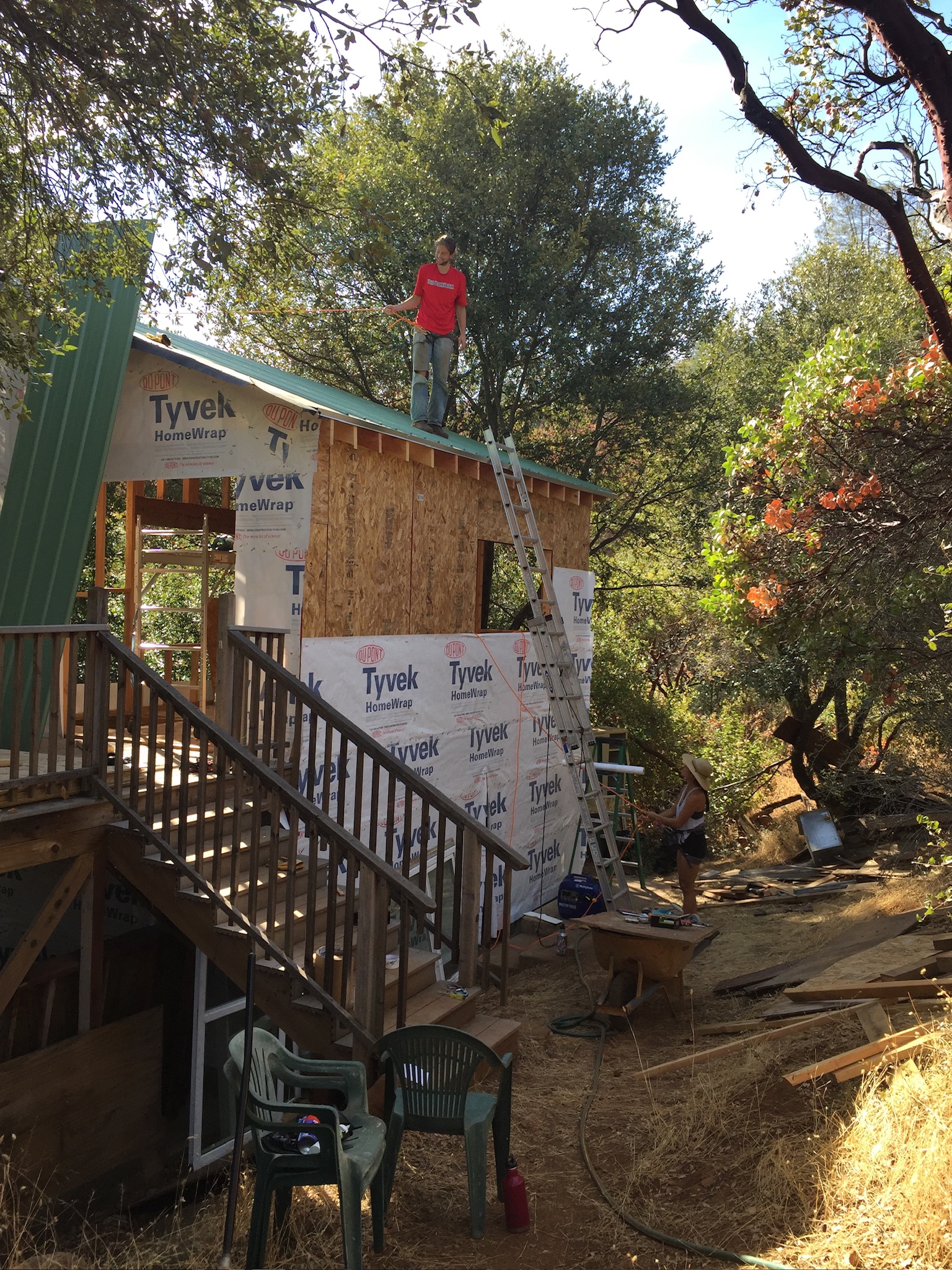 John on the roof of a tiny home he built from the ground up